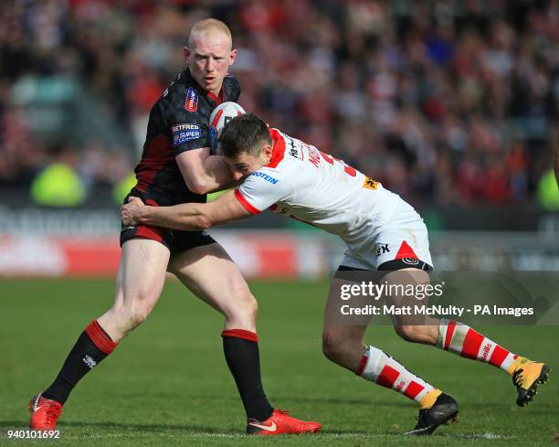 St Helens' Ryan Morgan tackles Wigan Warriors' Liam Farrell during the Super League match at the Totally Wicked Stadium, St Helens.