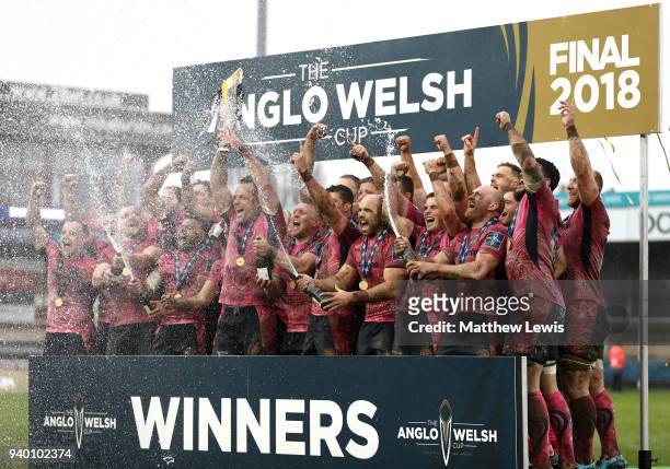Kai Horstmann of Exeter Chiefs lifts the Anglo-Welsh Cup trophy and celebrates with team mates after winning the Final between Bath Rugby and Exeter...