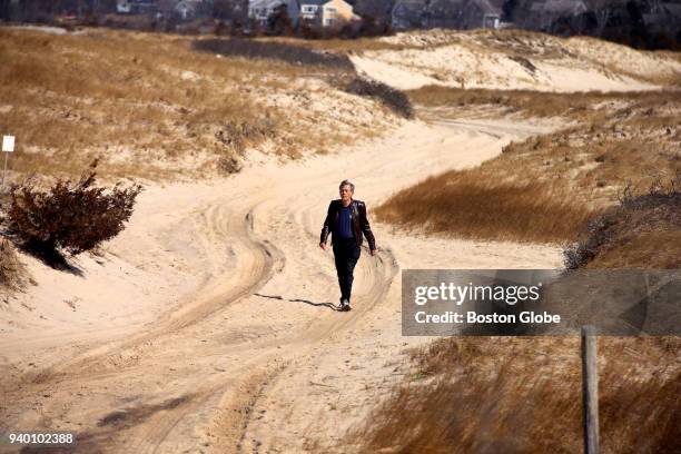 George MacDonald, chairman of the Dennis Conservation Commission, walks along the four-wheel drive access road to the Crowes Pasture flats and beach...