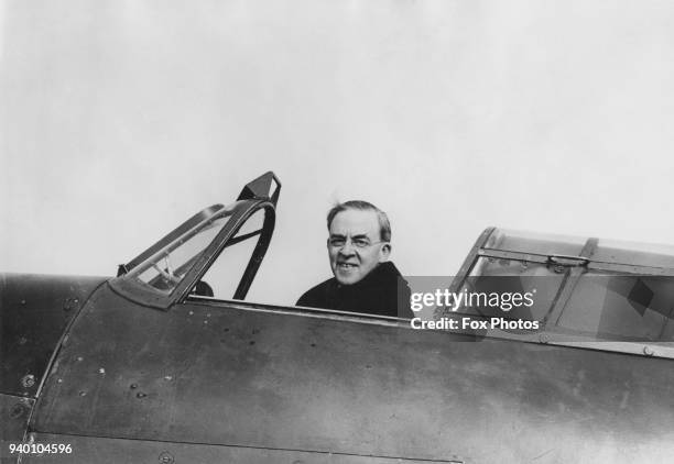 Sir Stafford Cripps , the Minister of Aircraft Production, in the cockpit of an aircraft, circa 1943.