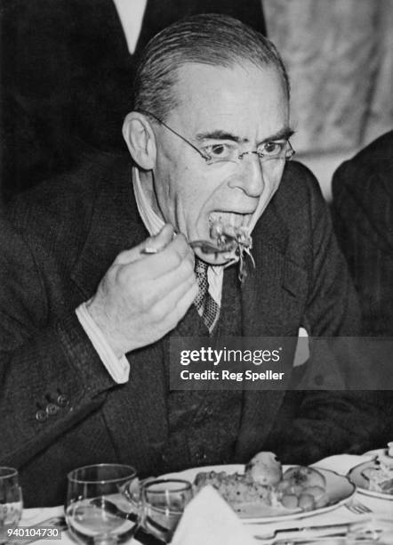 Sir Stafford Cripps , the Minister of Aircraft Production, eats raw fruit and vegetables at a lunch held by the Parliamentary Scientific Association...