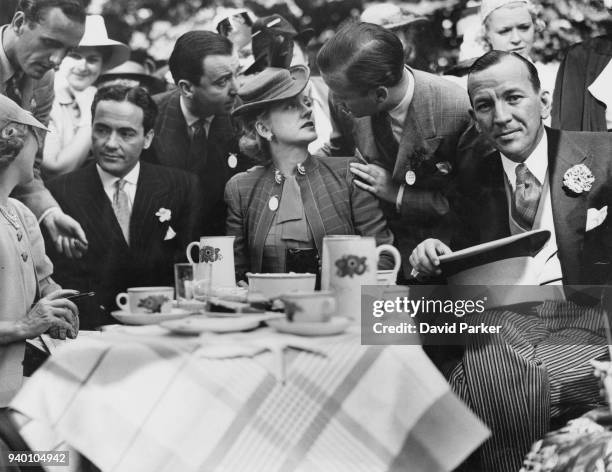From left to right, actors Mary Pickford, her husband Charles 'Buddy' Rogers, Evelyn Laye and her husband Frank Lawton, and Noël Coward at a...