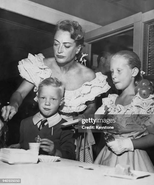American actress Joan Crawford with her children Christopher and Christina, circa 1947.