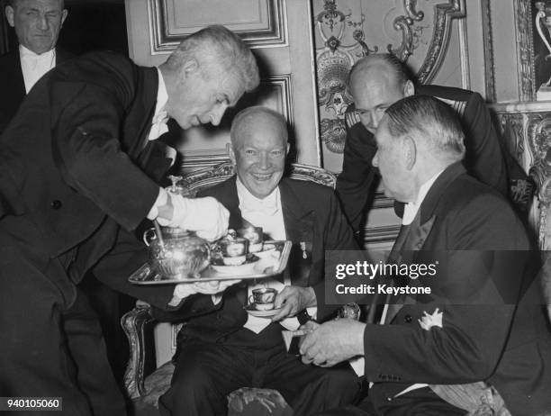 French President René Coty takes coffee with US President Dwight D. Eisenhower at the Elysée Palace in Paris, France, after throwing a State Banquet...