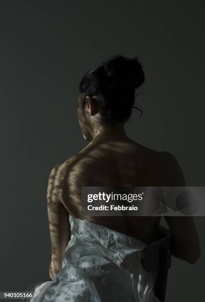 portrait of woman back with whadow pattern - hair back stock pictures, royalty-free photos & images