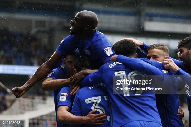 Sol Bamba of Cardiff City joins Kenneth Zohore of Cardiff City celebrates scoring his sides first goal of the match with Junior Hoilett during the...