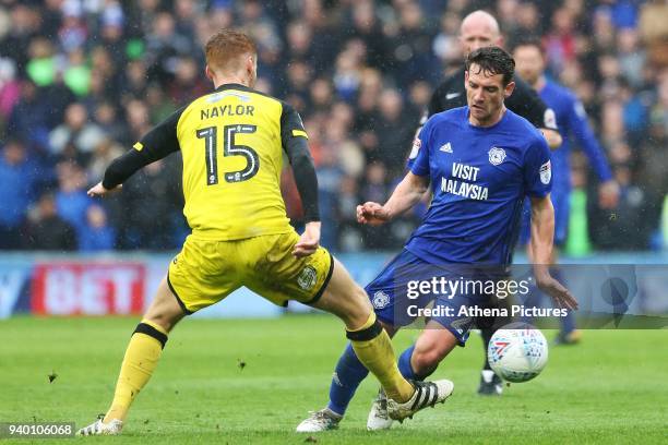 Craig Bryson of Cardiff City is tackled by Tom Naylor of Burton Albion during the Sky Bet Championship match between Cardiff City and Burton Albion...