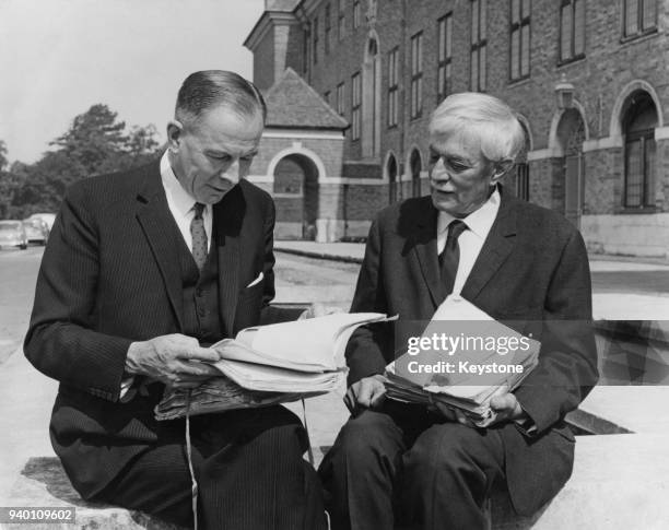 Henry Williamson , author of 'Tarka the Otter' and other books, presents several of his original manuscripts to Sir James Wilfred Cook , the...