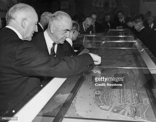 Sir Eric Harrison , the Australian High Commissioner in London, looks at a model of the Port of London with John Fremantle, 4th Baron Cottesloe ,...