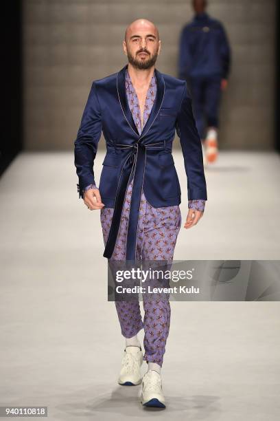 Soner Sarikabadayi walks the runway at the Emre Erdemoglu show during Mercedes Benz Fashion Week Istanbul at Zorlu Performance Hall on March 30, 2018...