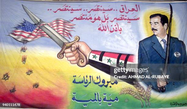 Painting depicting Iraqi President Saddam Hussein with a sword piercing a US flag appears in Baghdad 24 March 2003. A defiant President Saddam...