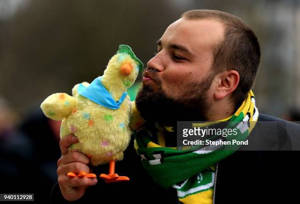 Norwich City fan kisses an easter chick dressed as a canary during the Sky Bet Championship match between Norwich City and Fulham at Carrow Road on...