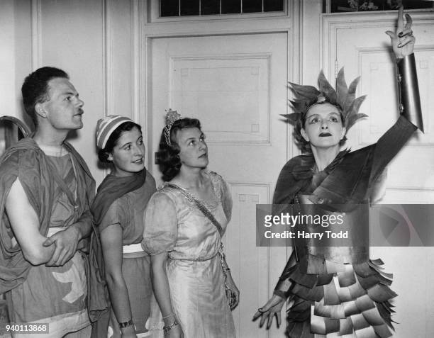 English actress Gladys Cooper gives acting tips to players from the London Passenger Transport Board , whilst appearing as Oberon in Shakespeare's 'A...