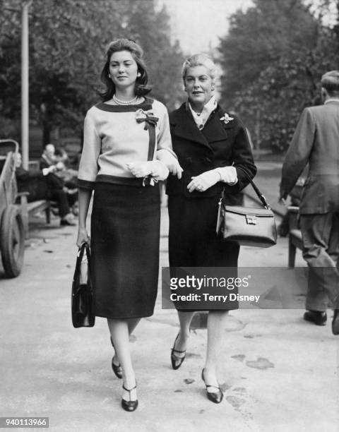 American actress Veronica Cooper , the wife of actor Gary Cooper, walking in Embankment Gardens, London, with their daughter Maria, 29th September...