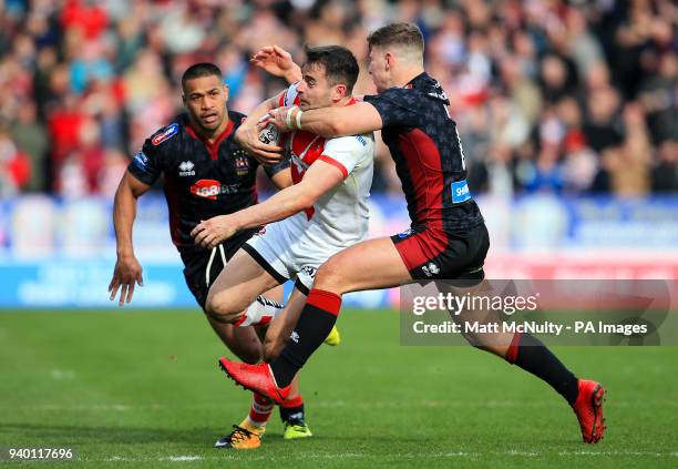 St Helens' Ryan Morgan is tackled during the Super League match at the Totally Wicked Stadium, St Helens.