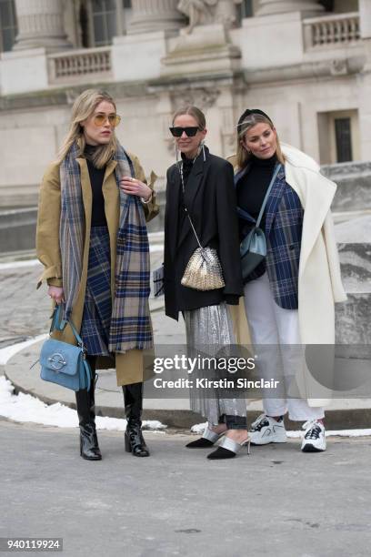 Fashion blogger Annabel Rosendahl wears a JW Anderson bag, TIBI coat, Victoria Beckham sunglasses, Acne scarf, boots and skirt with Fashion blogger...