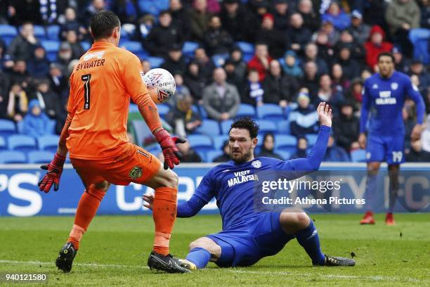 Sean Morrison of Cardiff City attempts to chip keeper Stephen Bywater of Burton Albion during the Sky Bet Championship match between Cardiff City and...