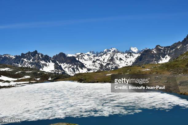 the lake of the snakeand massif of ecrins - ecrin national park stock pictures, royalty-free photos & images