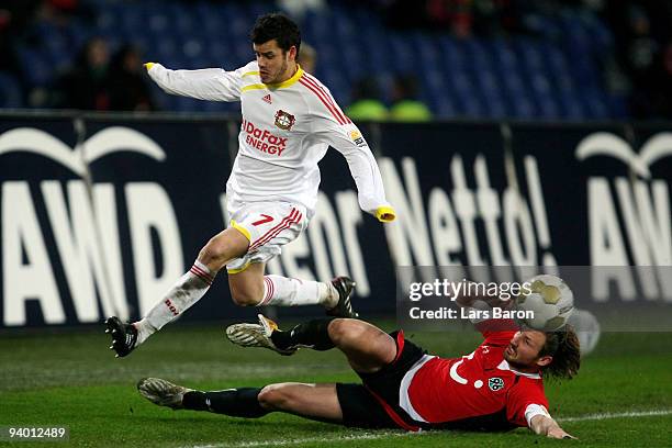 Tranquillo Barnetta of Leverkusen is challenged by Christian Schulz of Hannover during the Bundesliga match between Hannover 96 and Bayer Leverkusen...