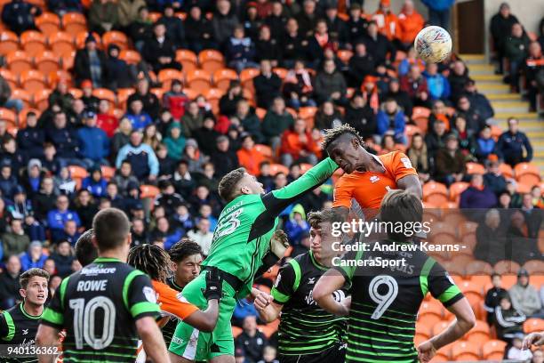 Doncaster Rovers' Marko Marosi punches clear under pressure from Blackpool's Armand Gnanduillet during the Sky Bet League One match between Blackpool...