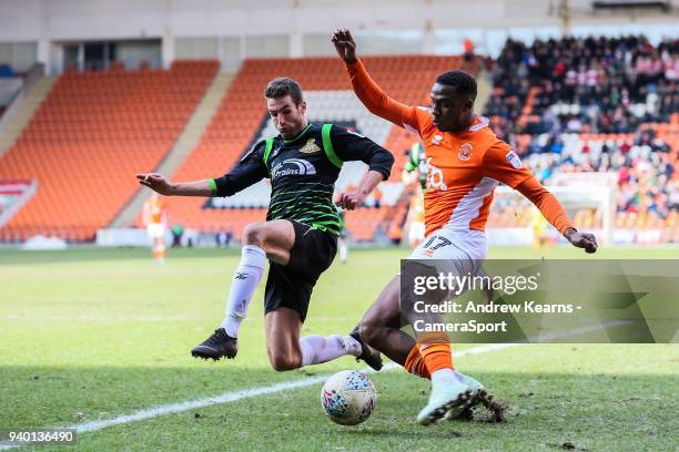 Blackpool's Viv Solomon-Otabor crosses under pressure Doncaster Rovers' Matty Blairduring the Sky Bet League One match between Blackpool and...