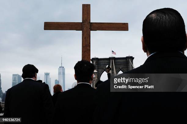 Worshippers walk to a station during the Way of the Cross procession over the Brooklyn Bridge on March 30, 2018 in New York City. The Way of the...