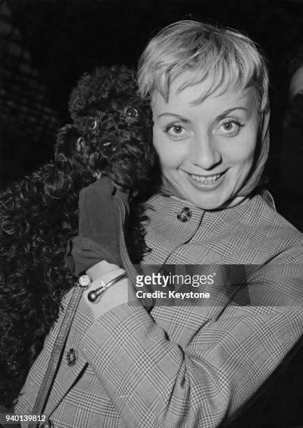 Belgian actress and singer Annie Cordy arrives at the Gare du Nord in Paris, France, with her new poodle 'New York II', 30th September 1957. She has...
