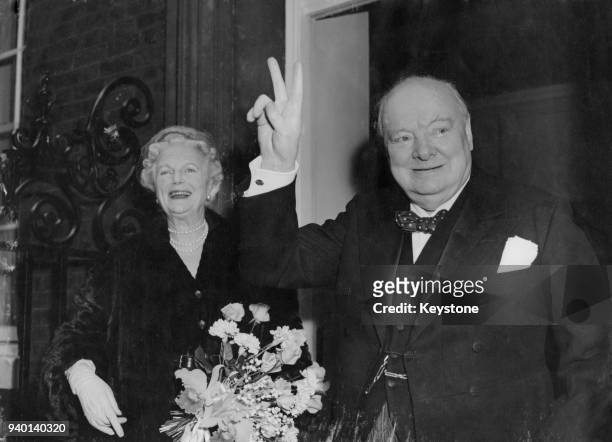 British Prime Minister Winston Churchill returns to 10 Downing Street in London with his wife Clementine, after his 80th birthday celebrations in...