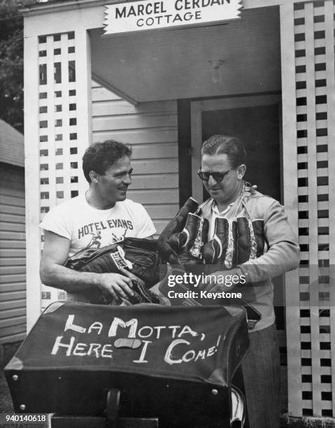 French boxer and World Middleweight champion Marcel Cerdan and his manager Joe Longman leave Marcel Cerdan Cottage in the Hotel Evans, Loch...
