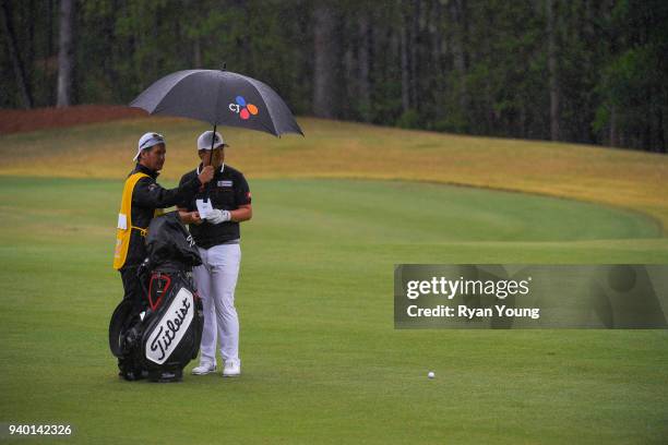 Sungjae Im discusses strategy with his caddy on the fourth hole during the second round of the Web.com Tour's Savannah Golf Championship at the...