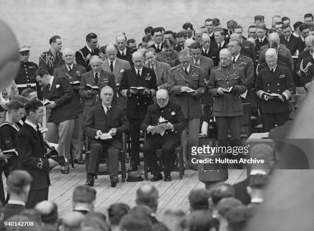 President Franklin D. Roosevelt poses with British Prime Minister Winston Churchill after a church service on the battleship 'Prince of Wales' during...