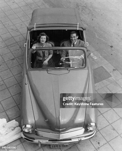 British actress Sarah Churchill , daughter of statesman Winston Churchill, and her husband Anthony Beauchamp try out their new Hillman Minx at their...