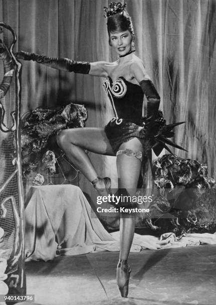 American actress and dancer Cyd Charisse appears in 'Deuil en 24 Heures', one of four segments of the film 'Black Tights' directed by Terence Young,...