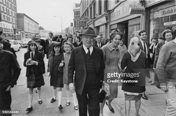 Comic actor Charlie Chaplin out walking with his wife Oona on the Old Kent Road, near his birthplace in Southwark, London, 11th May 1966. Chaplin is...