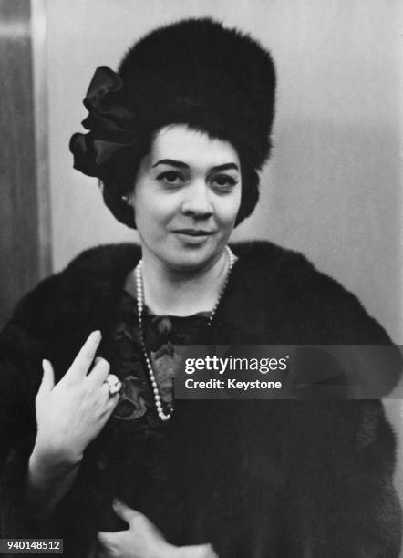 Italian mezzo-soprano Fiorenza Cossotto visits the Peter Robinson store in the Strand, London, to buy a new winter hat, circa 1965. She is appearing...
