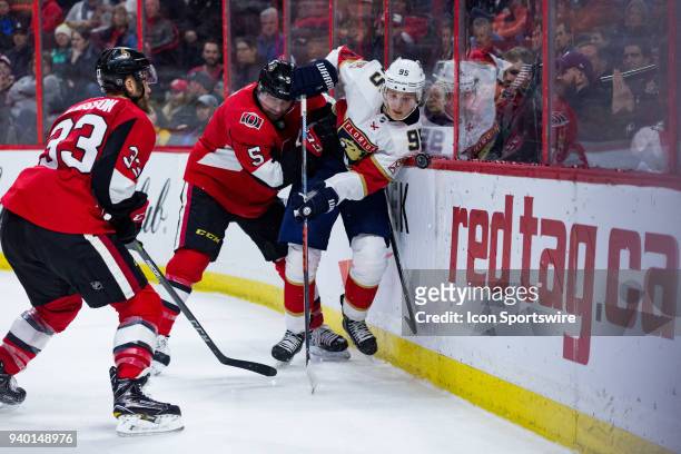 Florida Panthers Center Henrik Borgstrom is pinned to the boards by Ottawa Senators Defenceman Cody Ceci during third period National Hockey League...