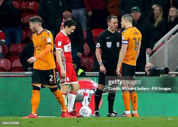 Match referee Stuart Atwell speaks with Wolverhampton Wanderers' Conor Coady during the Sky Bet Championship match at Riverside Stadium,...