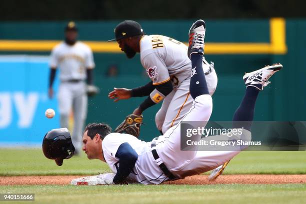 Mikie Mahtook of the Detroit Tigers slides into second base for a second inning double in front of Josh Harrison of the Pittsburgh Pirates during...