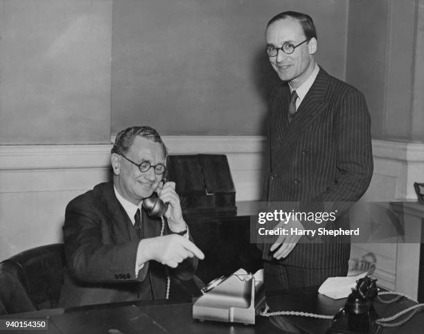 William Hare, 5th Earl of Listowel , the Postmaster-General, watches John Cliff , Chairman of the LCC make the first call on the Post Office system's...