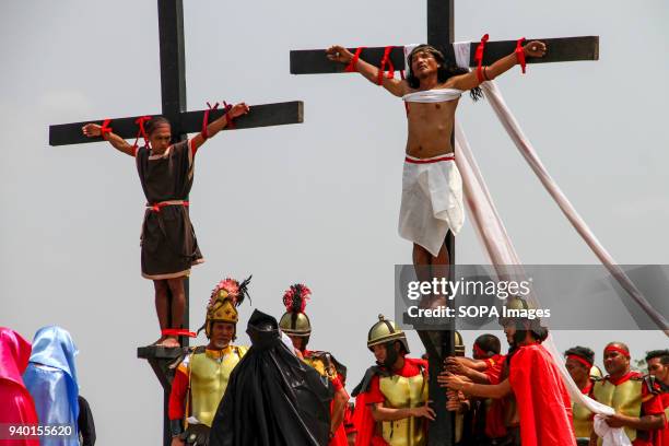 Fifty-eight year old Ruben Enaje on the cross for the 32nd year. Good Friday crucifixion rights were held in Cutud, Pampanga during the annual...