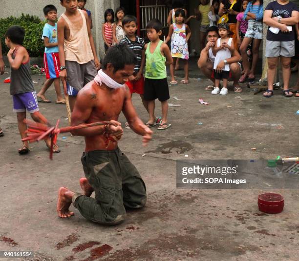 Flagellant whips his back. Good Friday in the Philippines consist of different rituals like flagellation or doing self inflicting wound to the body....