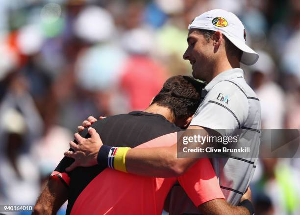 John Isner of the United States shakes hands at the net after his straight sets victory against Juan Martin Del Potro of Argentina in their semifinal...