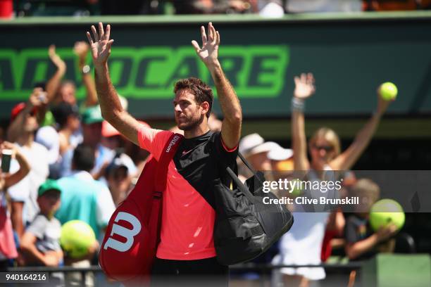 Juan Martin Del Potro of Argentina waves to the crowd as he walks off court after his straight sets defeat by John Isner of the United States in...