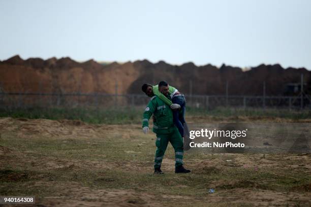 Palestinian medics evacuated an injured man during a demonstration near the border with Israel east of Jabalya in the Gaza Strip to commemorate the...