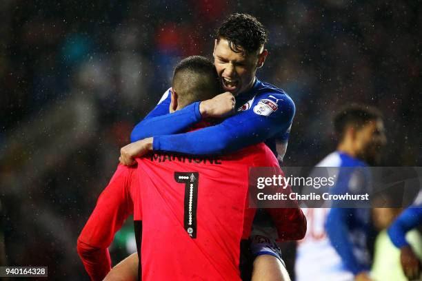 Reading's George Evans celebrates with Vito Mannone after he saves a penalty during the Sky Bet Championship match between Reading and Queens Park...