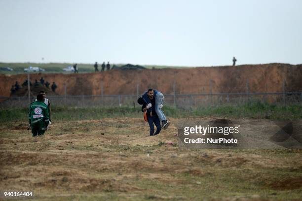 Palestinian medics evacuated an injured man during a demonstration near the border with Israel east of Jabalya in the Gaza Strip to commemorate the...