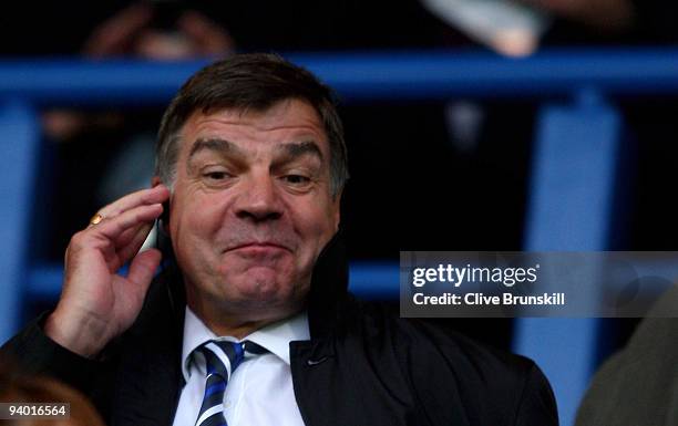 Blackburn Rovers manager Sam Allardyce uses his radio to communicate with his coaching staff on the bench during the Barclays Premier League match...