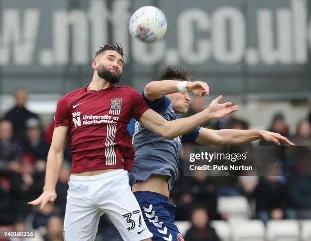 Jordan Turnbull of Northampton Town contests the ball with Michal Zyro of Charlton Athletic during the Sky Bet League One match between Northampton...