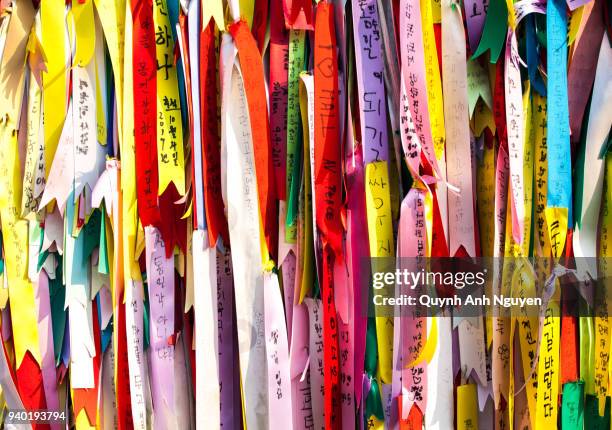 colorful bows and ribbons hang on fence at dmz area of south and north korea - gap closers stock pictures, royalty-free photos & images