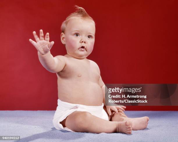 1960s BABY WEARING CLOTH DIAPER HOLDING HAND UP IN HALT STOP GESTURE WAVING GOODBYE